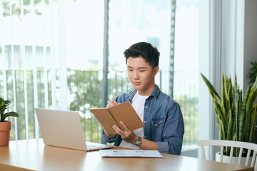 Male freelancer connecting to internet via computer.