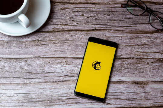 02-05-2021 Portsmouth, Hampshire, UK A mobile phone or cell phone laid on a wooden table or desk with the mailchimp app open