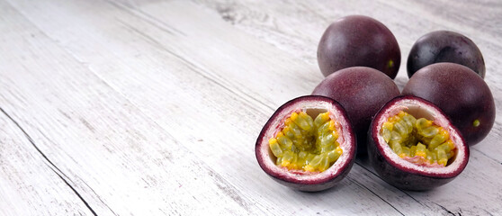 Fresh passion fruits on wooden table with copy space