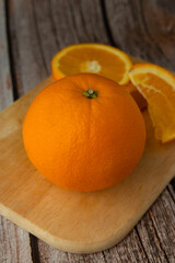Beautiful Oranges Full and Sliced on old wooden backgroung. rich with vitamins.texture.