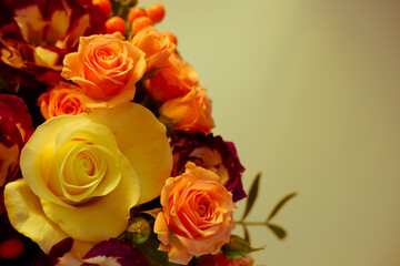 Fototapeta premium Background. Bouquet of flowers close-up on a white background illuminated by yellow, soft light. White and pink roses, blue-white eustoma. Place for text.