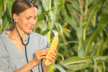 Crop care concept, woman with a stethoscope holding a cob	