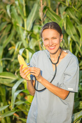 Crop care concept, woman with a stethoscope holding a cob	