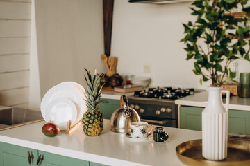 Healthy breakfast, a glass of fresh grapefruit, mango, pineapple white dishes, coffee tea. Soft selective focus.