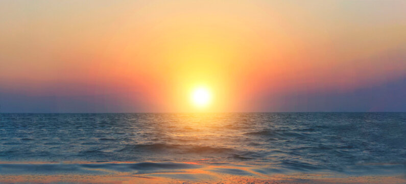 Defocused  image of beautiful sunrise above sea water, horizontal banner. Sea, water, landscapes concept.