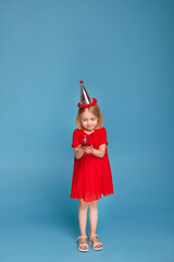 little girl with cake on her birthday on a blue background