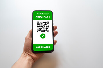 Vaccinated person using digital health passport application on mobile phone to travel during the COVID-19 pandemic