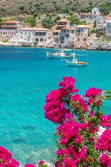 Limeni village with the famous  stone buildings a blooming bougainvillea, and turquoise waters in...