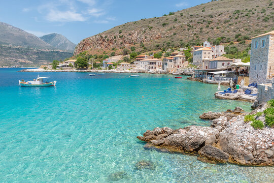 view of  Limeni village with fishing boats in  turquoise waters and the stone buildings as a background  in Mani, South Peloponnese , Greece.