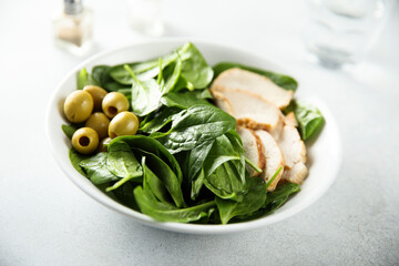 Healthy spinach salad with chicken and olives