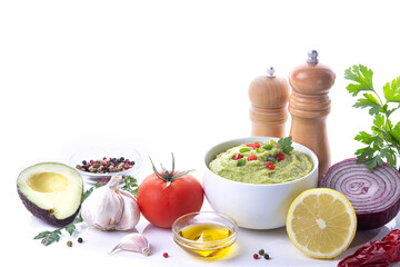 Bowl of guacamole and ingredients on white background  with copy space.