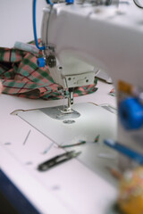 Professional white sewing machine in a tailor workshop