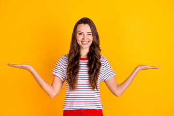Portrait of attractive cheerful girl holding on palms copy empty space offer winking solution...