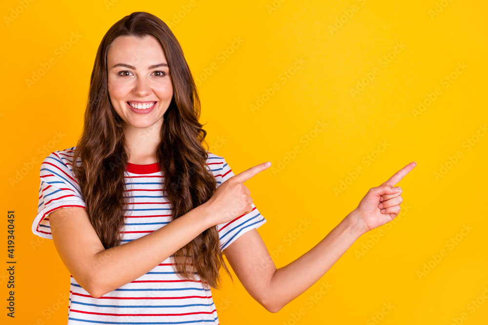 Poster portrait of attractive cheerful girl demonstrating copy empty blank place space isolated over bright