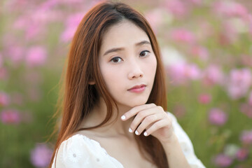 Fototapeta premium Beautiful young woman with white dress on garden background