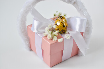 The minimal concept of Easter. A copy of the space. Pink gift box and Easter egg.