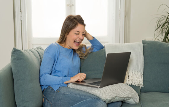 Happy Young Woman On Zoom Video Calling Family And Friends Using Laptop During Social Distancing