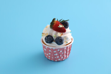 Fruits cupcake isolated in blue background