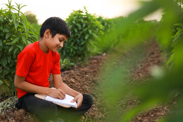 Cute indian little child studying at agriculture field