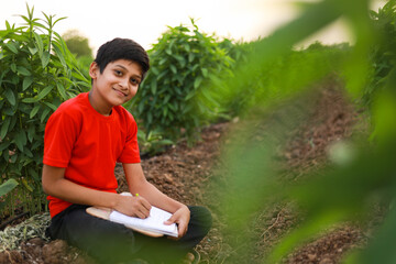 Cute indian little child studying at agriculture field