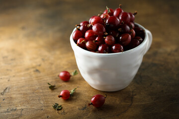 Fresh gooseberry in a white cup
