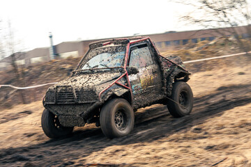 Fototapeta na wymiar Dirty 4x4 vehicle starting in a off road competition. Dynamic shot of car on in the off road circuit race