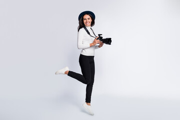 Full length photo of lovely stunning young woman jump up air smile cameraman isolated on grey color...