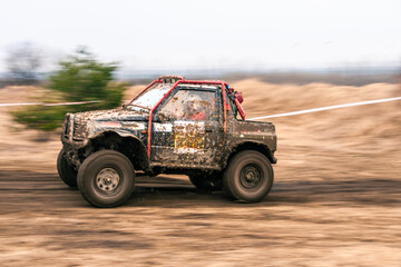 Dirty 4x4 vehicle starting in a off road competition. Dynamic shot of  car on  in the  off  road circuit race