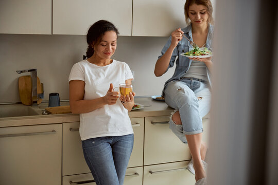 Relaxed females enjoying their dinner at home