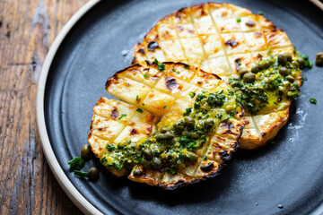 Roasted celeriac steak with capers and herb sauce
