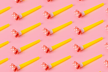 Birthday party whistles on pink background, colorful celebration pattern with party blower horns,...