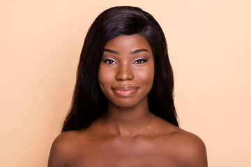 Photo of adorable smiling dark skin nude woman smooth fresh skin isolated beige color background