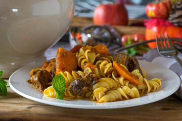 Pumpkin stew with beef and pasta on a plate