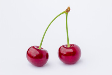 two cherries on a white background,
ripe cherry