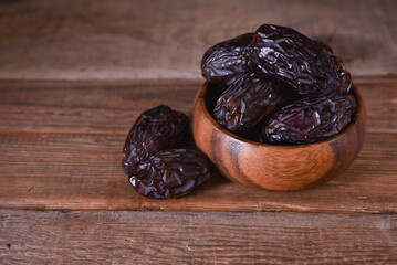royal dates in a wooden bowl on the table with copy space