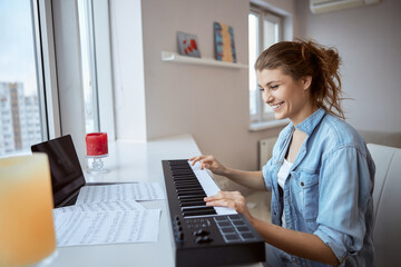 Happy brunette woman studying to play new melody