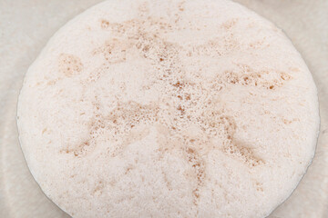 Macro shot of  raw ripening yeast in a glass dish, standing on the table.