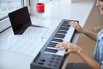 Close up of female that playing synthesizer