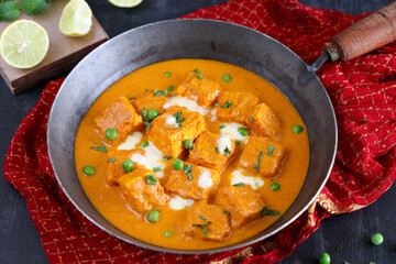Matar Paneer curry, paneer butter masala recipe made using cottage cheese, green peas, served in a bowl.  Delhi, Rajasthan India. Indian veg curry wooden background. side dish of Roti, Chapati, naan