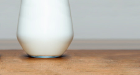 glass of milk on wooden board front view