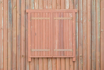 Closed Wooden Shutters on Window of Timber Building 