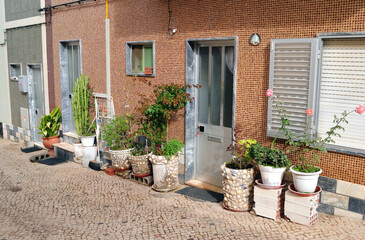 Cobbled Street with Decorative Plant Pots and Flowers