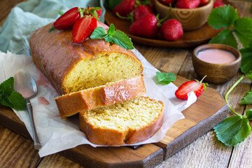 Delicious summer dessert strawberry pie with strawberry sugar icing, sweet delicious strawberry birthday cake on rustic table.