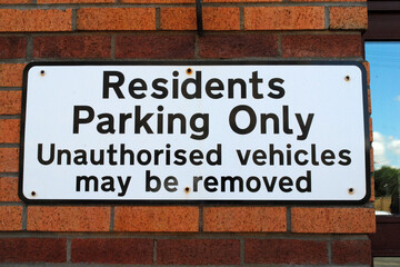 Prominent Metal Sign on Side of Building  'Residents Parking Only' 