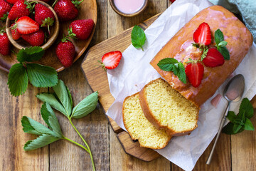 Delicious summer dessert strawberry pie with strawberry sugar icing, sweet delicious strawberry birthday cake on rustic table. Top view flat lay.