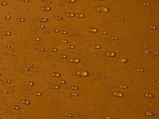 Random water drops on the gold PVC surface