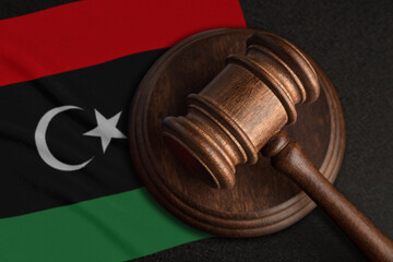 Judge gavel and flag of Libya. Law and justice in Libya. Violation of rights and freedoms