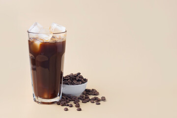 cold iced coffee on a beige background coffee beans, summer drink