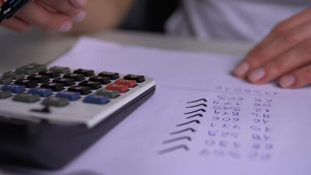 female hand typing on a calculator and collecting the correct result