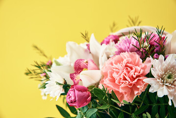 Bunch of fresh summer flowers on the yellow background